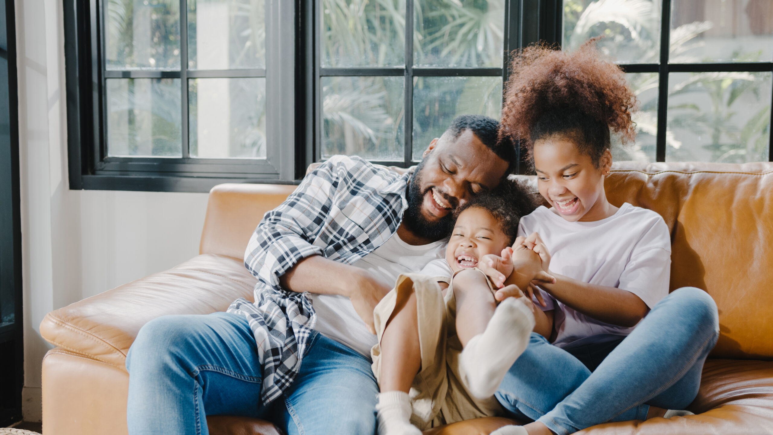 Happy cheerful African American family dad and daughter having f Happy cheerful African American family