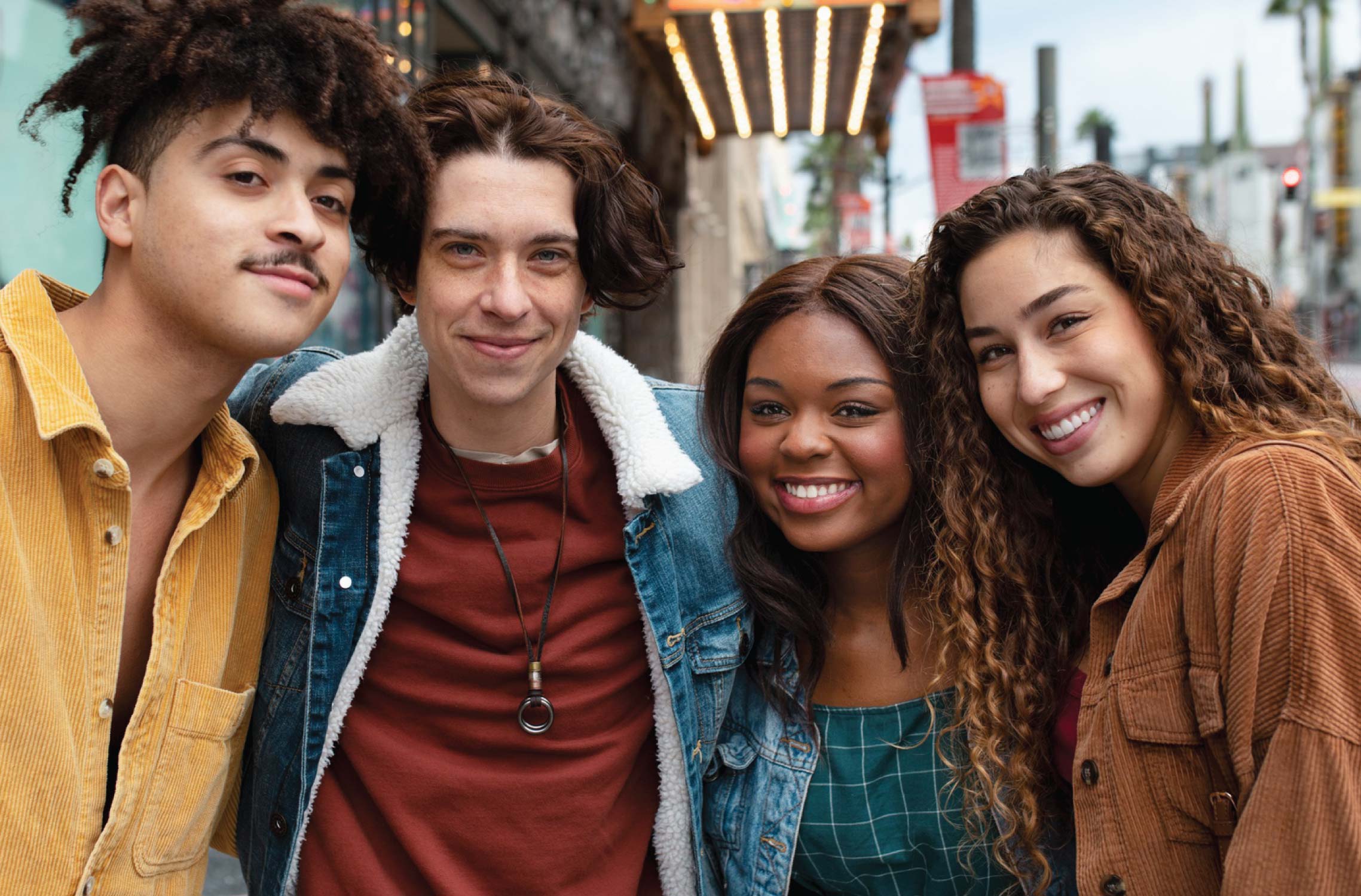 multicultural teens standing outside smiling