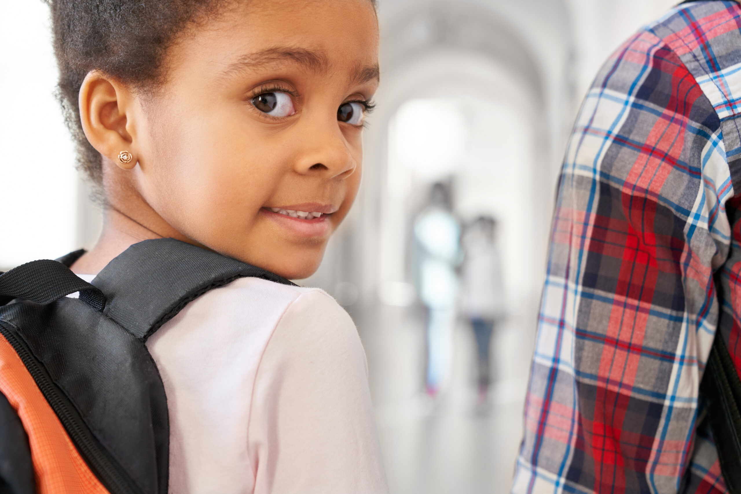 school girl looking at camera over shoulder. school girl looking at camera over shoulder.